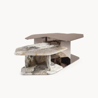 Elegant coffee table with low asymmetric geometry, polished white veined marble glazed to glossy sheen, and mirror‑finished steel reflecting warm bronze light