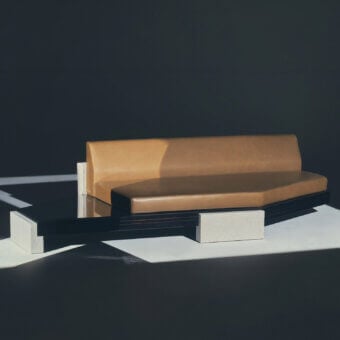 Sophisticated Visionnaire Stealth sofa with tan leather-like upholstery and high-gloss lacquered wood on off-white supports