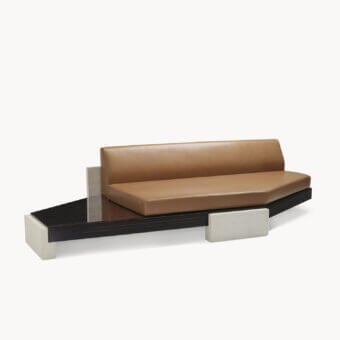 Elegant sofa with polygonal silhouette, dark glossy veneered wood base, smooth tan upholstery and off-white matte stone supports