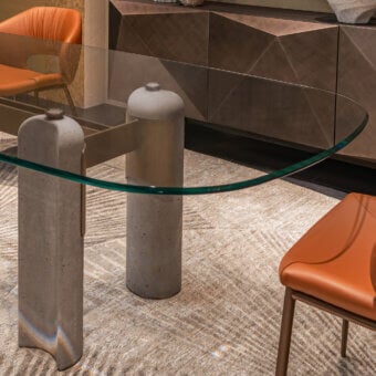 Exquisite Cattelan Italia Bilbao Glass Table with glossy oval transparent top, cement pillars and matte brown-grey metal