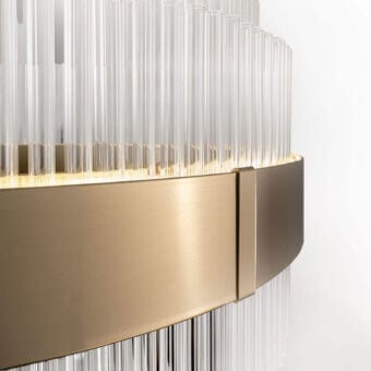 Luxury Italamp Olympia lamp with clear glass tubes, brushed brass band in warm gold, craftsmanship, subtle yellow glow