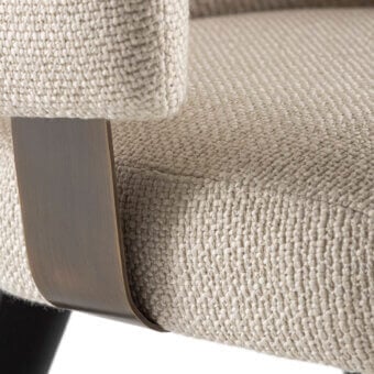 Exclusive Rugiano Charlotte armchair with beige‑cream upholstered armrest, matte black metal legs, bronze band base