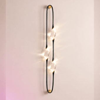 Sophisticated Il Pezzo 12 wall lamp with matte black wrought frame, glossy brass rings and handcrafted crystal diffusers