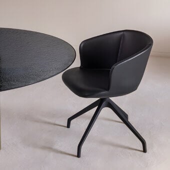 Elegant Sovet Italia Alika Swivel armchair in all‑black synthetic goud‑ek with soft subtle matte sheen