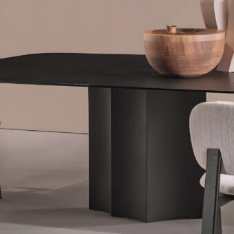 High-end Sovet Italia Iodo MAXI table with wooden top in deep black lacquer and metal pedestal displaying curves matte finish