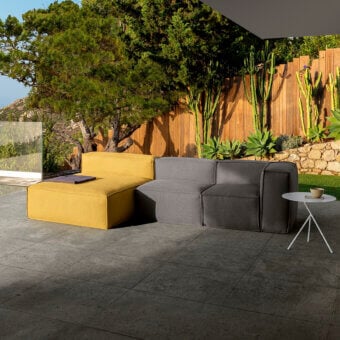 Elegant Talenti Ocean sectional with low‑profile, matte textile upholstery, mustard‑yellow chaise and charcoal‑grey two‑seater