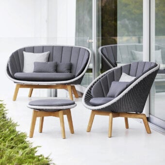 Luxury Cane-Line Peacock side table with grey textile seat and white synthetic woven rim, tapered wooden legs, curved lines