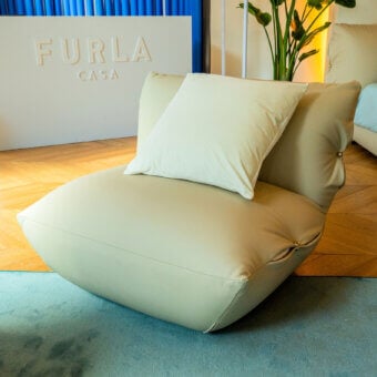 Sophisticated Furla Casa Cherry Blossom lounge chair in creamy beige leather with satin finish and organic silhouette