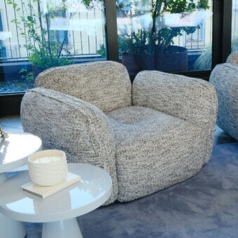 Architectural Furla Casa Moonstone lounge chair in mottled light gray textured fabric with solid black beech wood feet