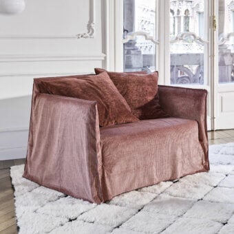 Luxury Gervasoni Ghost lounge chair in muted dusty‑rose ribbed textile slim frame padded cushioned with Dacron down
