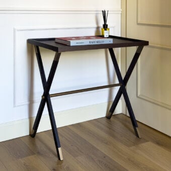 Architectural Vèlle Milano Aliseo side table crafted in solid wood with dark finish and brushed brass X frame base details