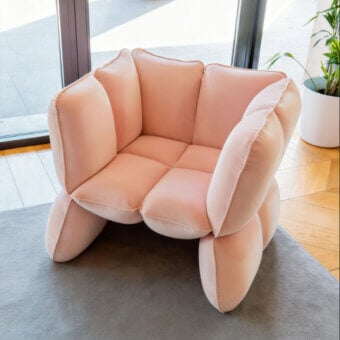 Captivating Furla Casa Fiore lounge chair in soft pale pink smooth fabric with metal frame and organic petal-like segments