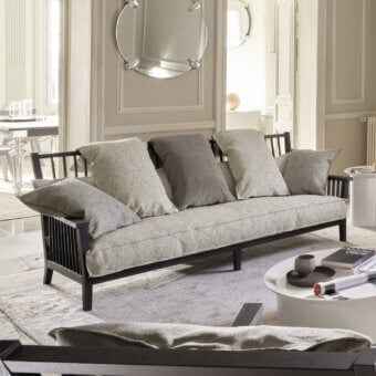 Refined Gervasoni Gray 03 sofa with textured cushions and low-profile matte black ash wood slatted frame