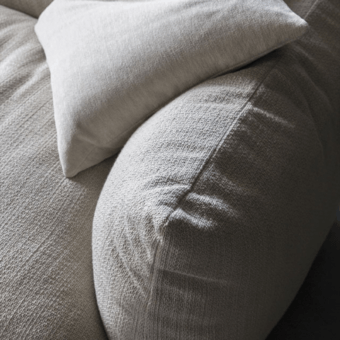 Luxury Mogg Alba sofa with organic silhouette, piped seams, and high-quality textured fabric in matte off-white finish