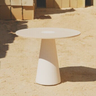 Sophisticated PIMAR Centro coffee table crafted from natural stone with a honed surface finish and conical pedestal base