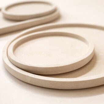 Luxury PIMAR Messapo trays in natural stone with a matte porous finish showcasing minimalist circular modular aesthetics