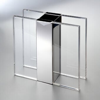 Refined Selezioni Domus Incastro vase featuring transparent synthetic panels and a mirror finish pillar
