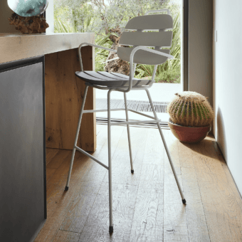 Sophisticated Slide Ribs Up stool with tubular metal frame and slatted seat in light gray matte finish