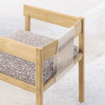 Elegant Unopiù Cora chair built using solid teak wood and pale cream synthetic cords