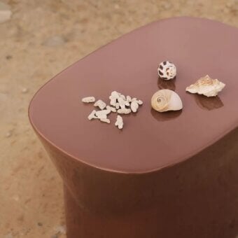 Luxury Unopiù Egadi stool in synthetic material with a monolithic silhouette curved edges and high-gloss terracotta finish