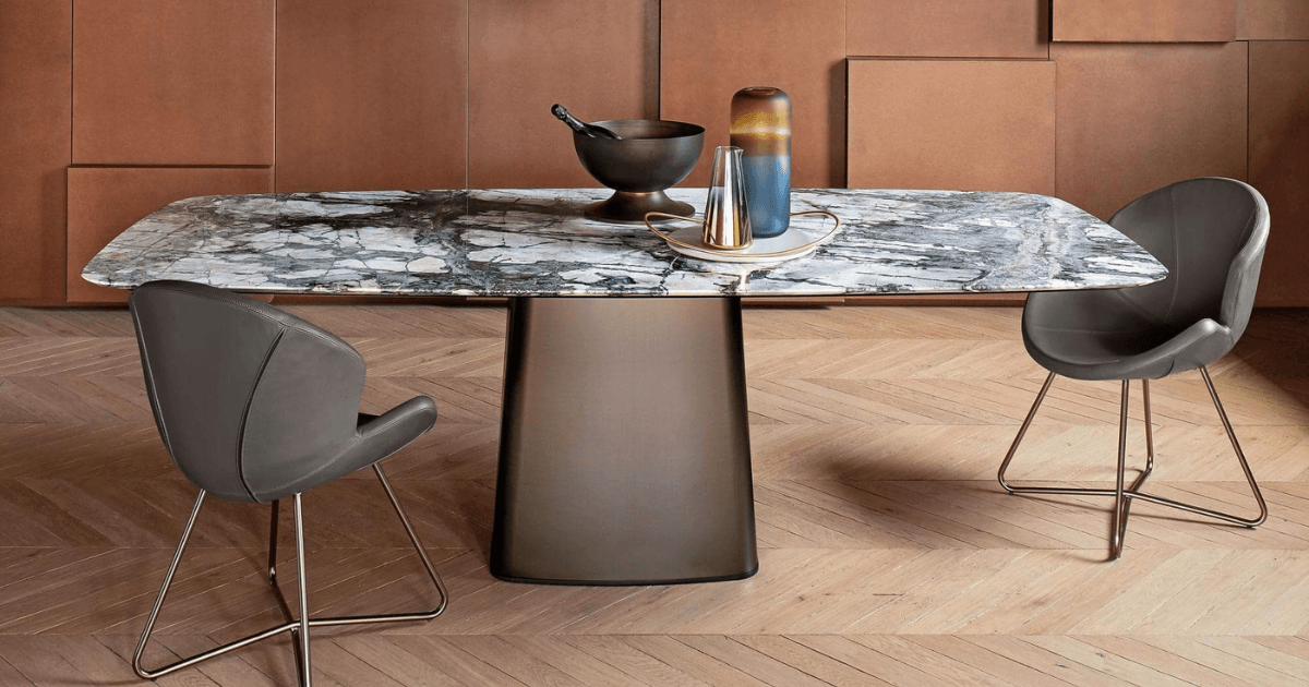 The table, chairs, and pendant lights build a composition through their proportions and placement.