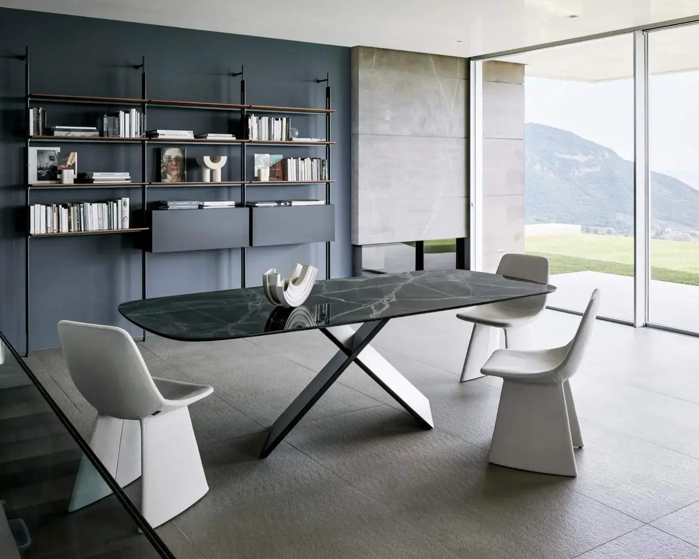 Elegant Bonaldo AX table with shaped ceramic top exhibiting subtle veining and glossy finish with painted metal X base