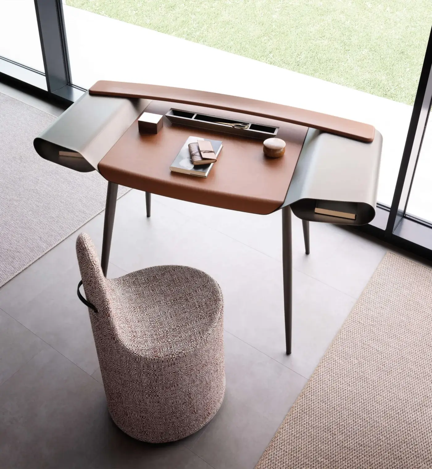Scritti presotto gulliver intro desk with brown leather-like top, curved light gray metal legs, and recessed dark gray detail in a modern interior.