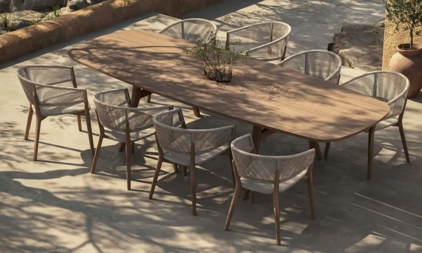 Elegant Royal Botania Zidiz dining table with teak wood frame and light beige woven seat presenting a matte finish