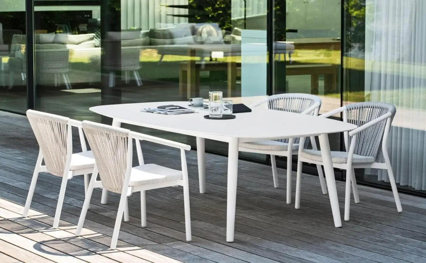 Distinguished Varaschin Ellisse table with a rounded rectangular shape and matte white HPL top crafted with powder-coated aluminum