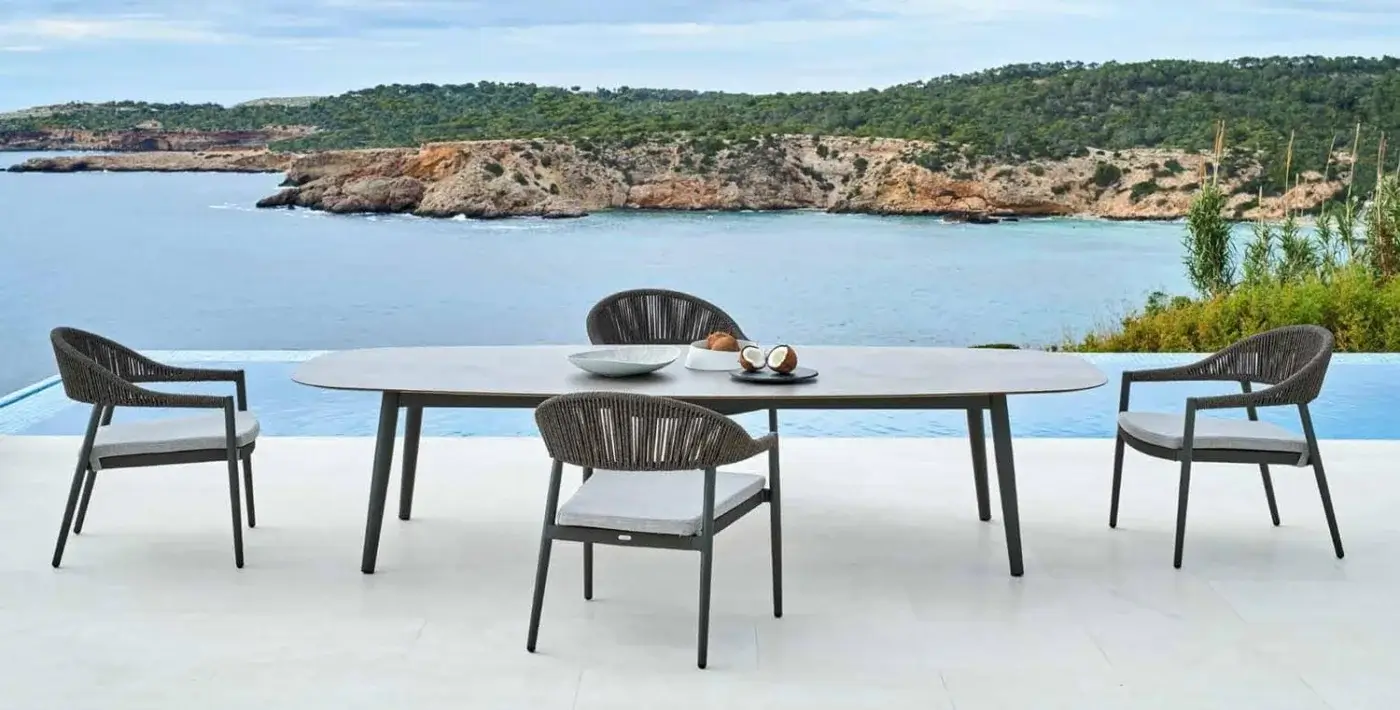 Elegant Varaschin Ellisse table with a light gray ceramic top and dark powder-coated aluminum legs