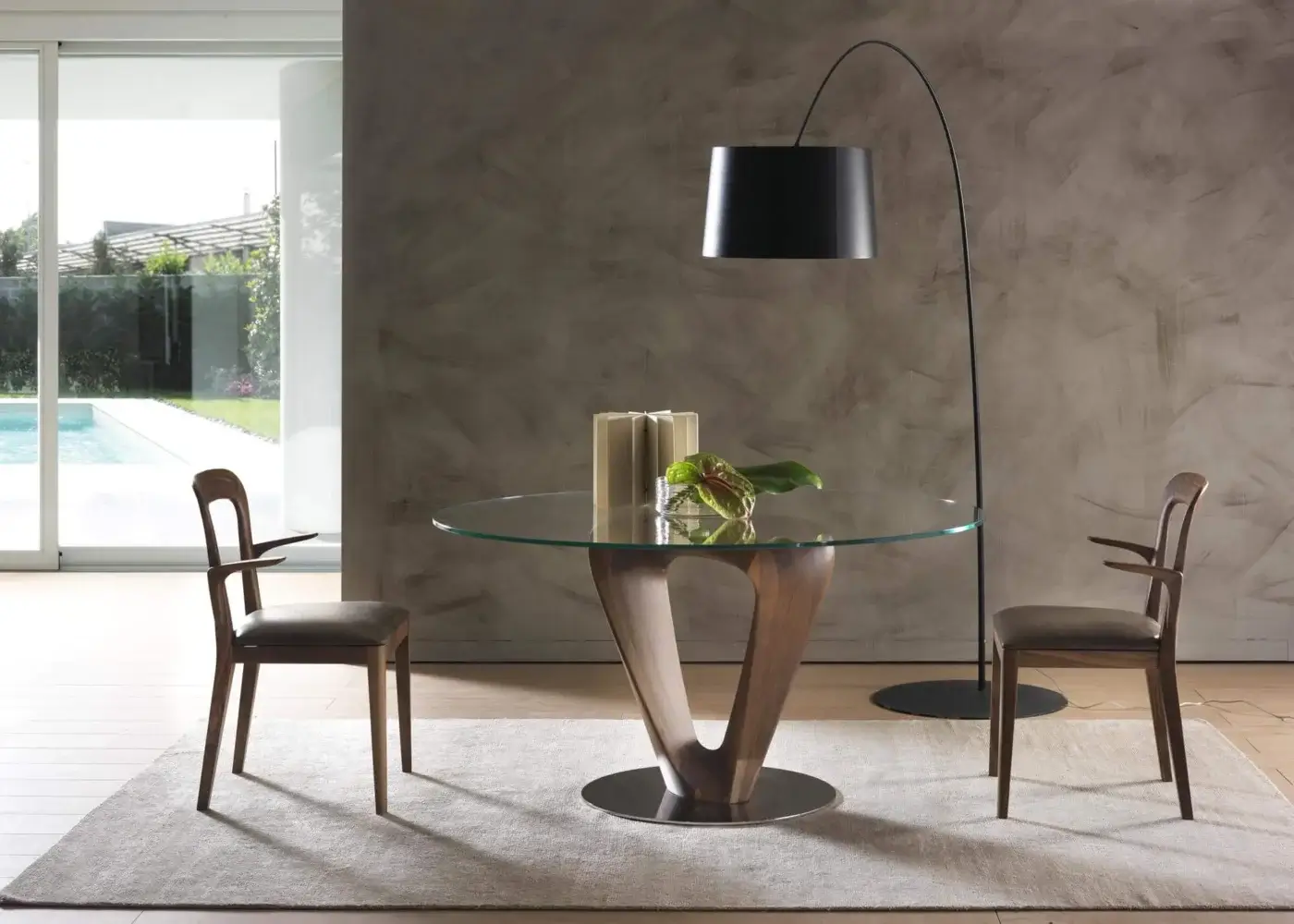 Harmonious Pacini & Cappellini Mobius table with a sinuous wooden base and transparent tempered glass top in chromed metal