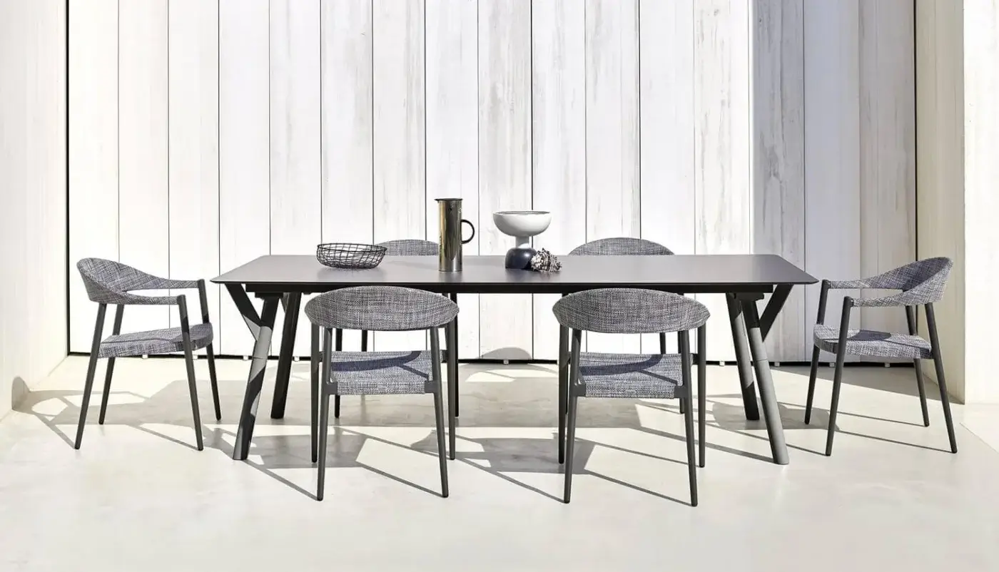 Refined Varaschin Clever armchair with a durable powder-coated aluminum frame and heathered gray VAR#TEX upholstery
