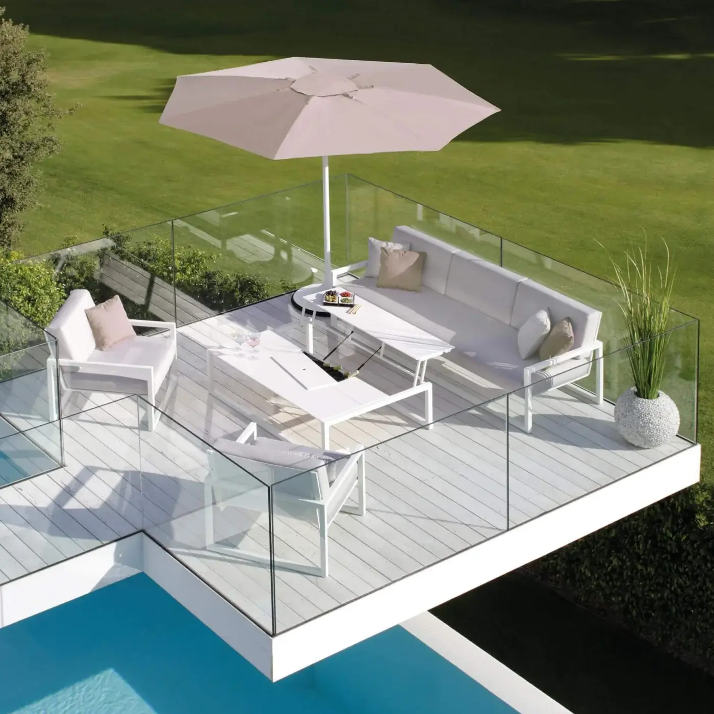 Superior Royal Botania Ninix lounge sofa with white fabric, Batyline seat and stainless steel frame, accented with beige pillows