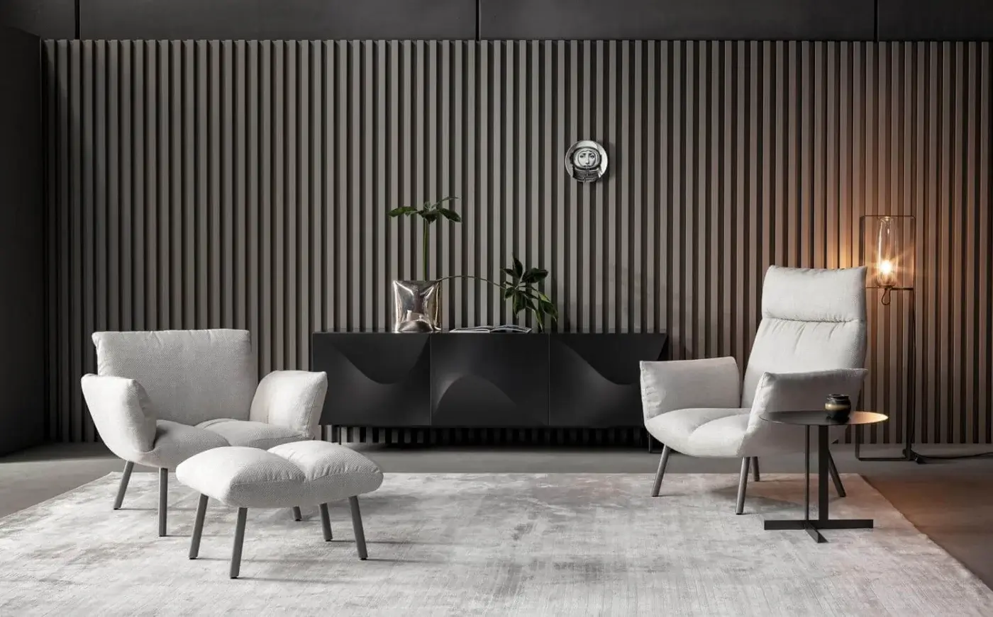 Distinguished Bonaldo Pil lounge chair with enveloping form upholstered in light gray textile and slender gray metal legs
