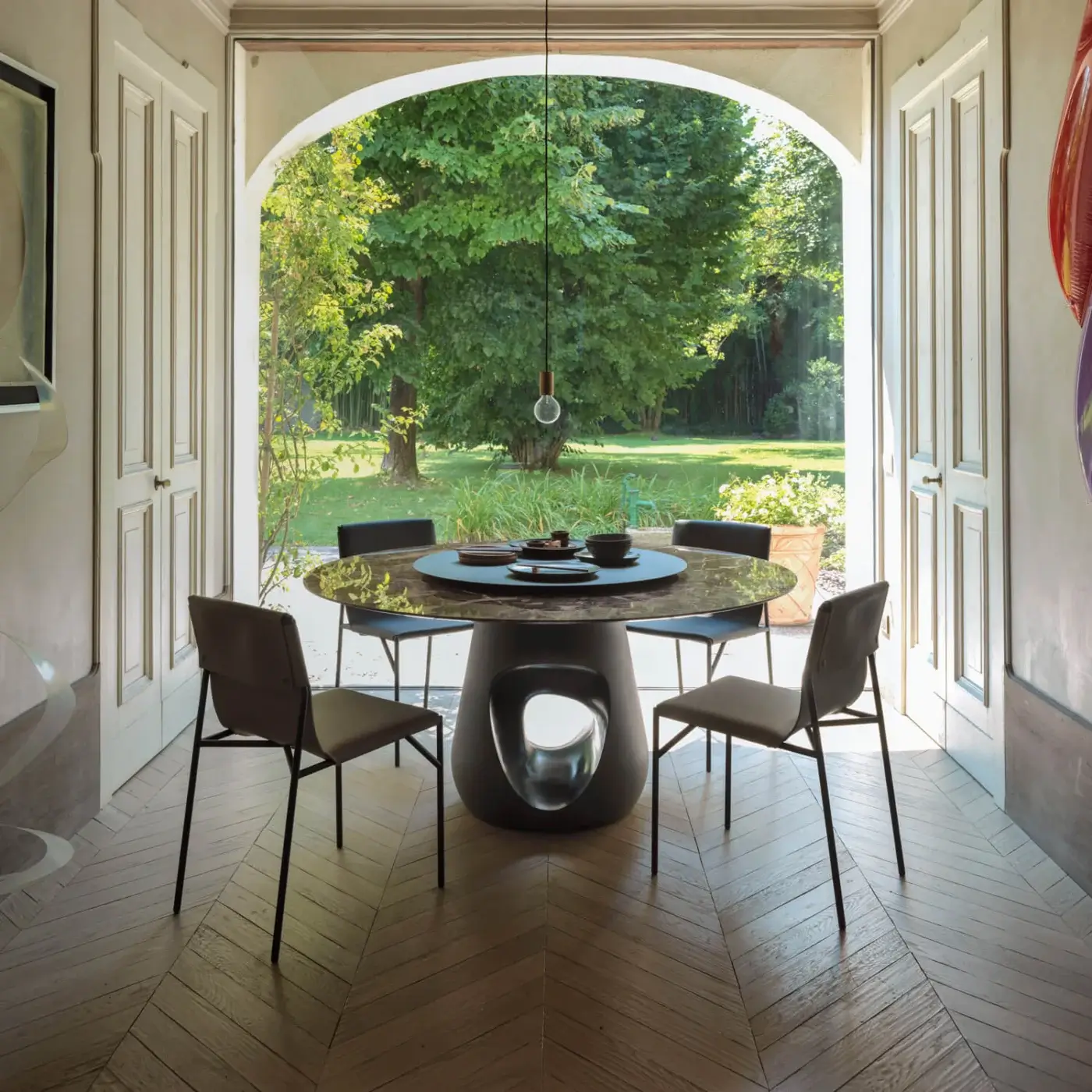 Superior Horm Barbara table with a round marble top and sculptural concrete base displaying a dark mottled finish