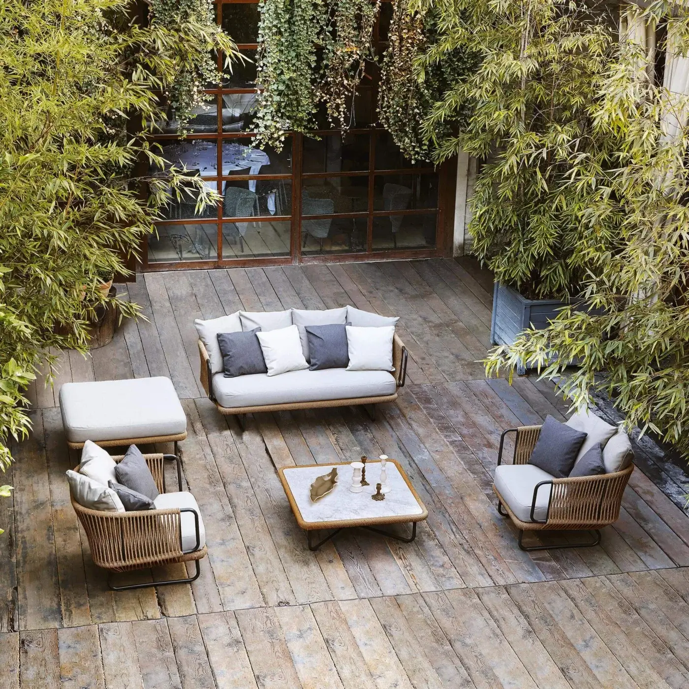 Distinguished Varaschin Babylon lounge chair crafted with light brown synthetic fiber rope on a varnished aluminum frame and plush gray cushions