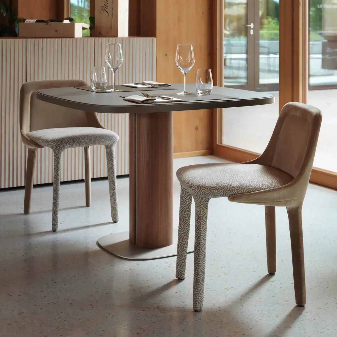 Distinguished Casamania Lepel chair upholstered in premium fabric with patterned legs and light beige matte finish