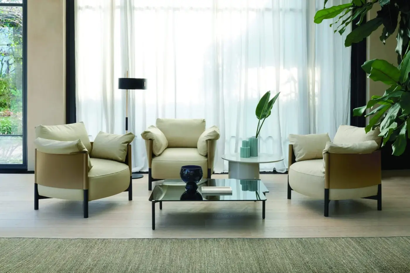 Superior Frag Syren lounge chair with a tubular metal frame and plush tan leather supporting beige textile cushions