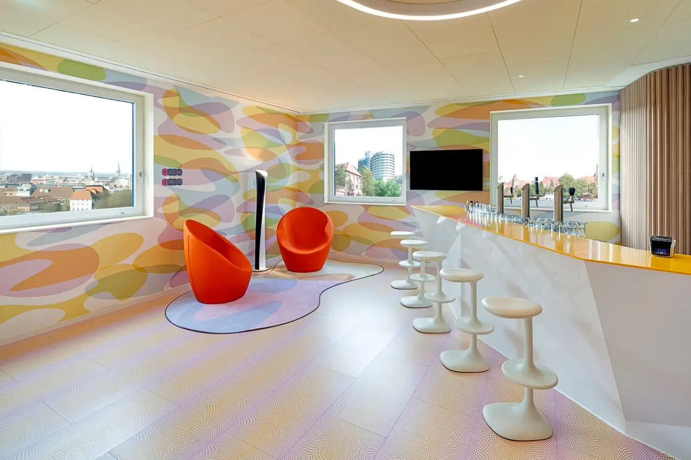 Superior Casamania Ouch lounge chair presents a voluptuous organic form upholstered in vibrant orange fire-retardant fabric with a metal structure