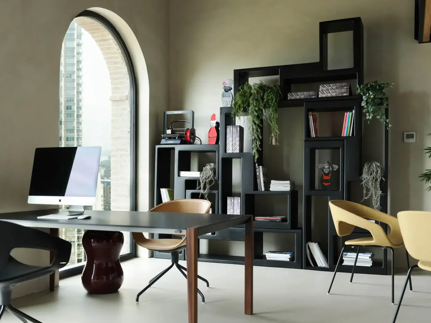 Distinguished Casamania Urban Bookcase shelving built in dark matte polyethylene with an asymmetrical carved monolithic form