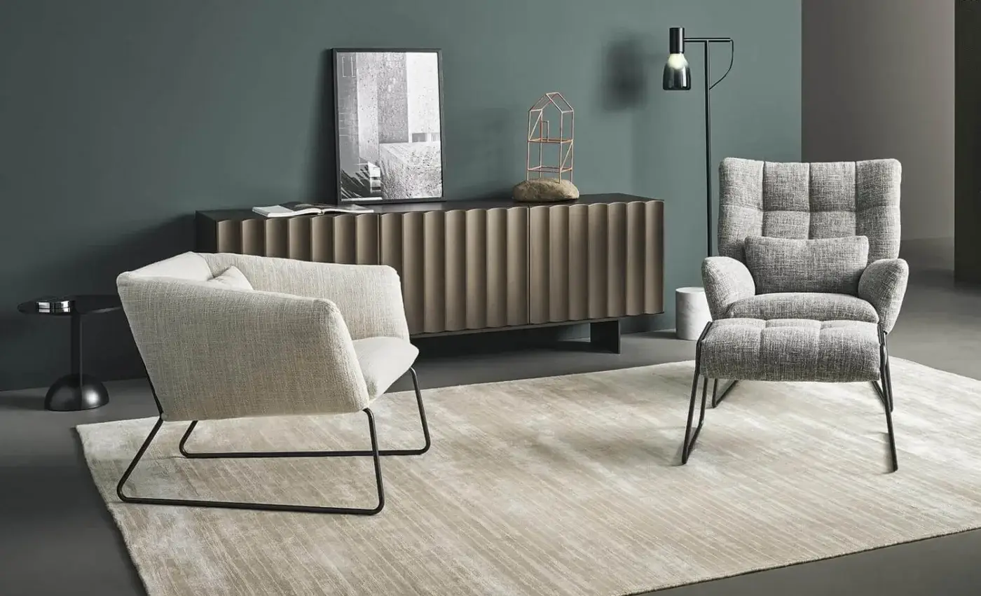 Exceptional Bonaldo Nikos lounge chair with a geometric silhouette and black painted metal sled base, upholstered in light beige textured fabric