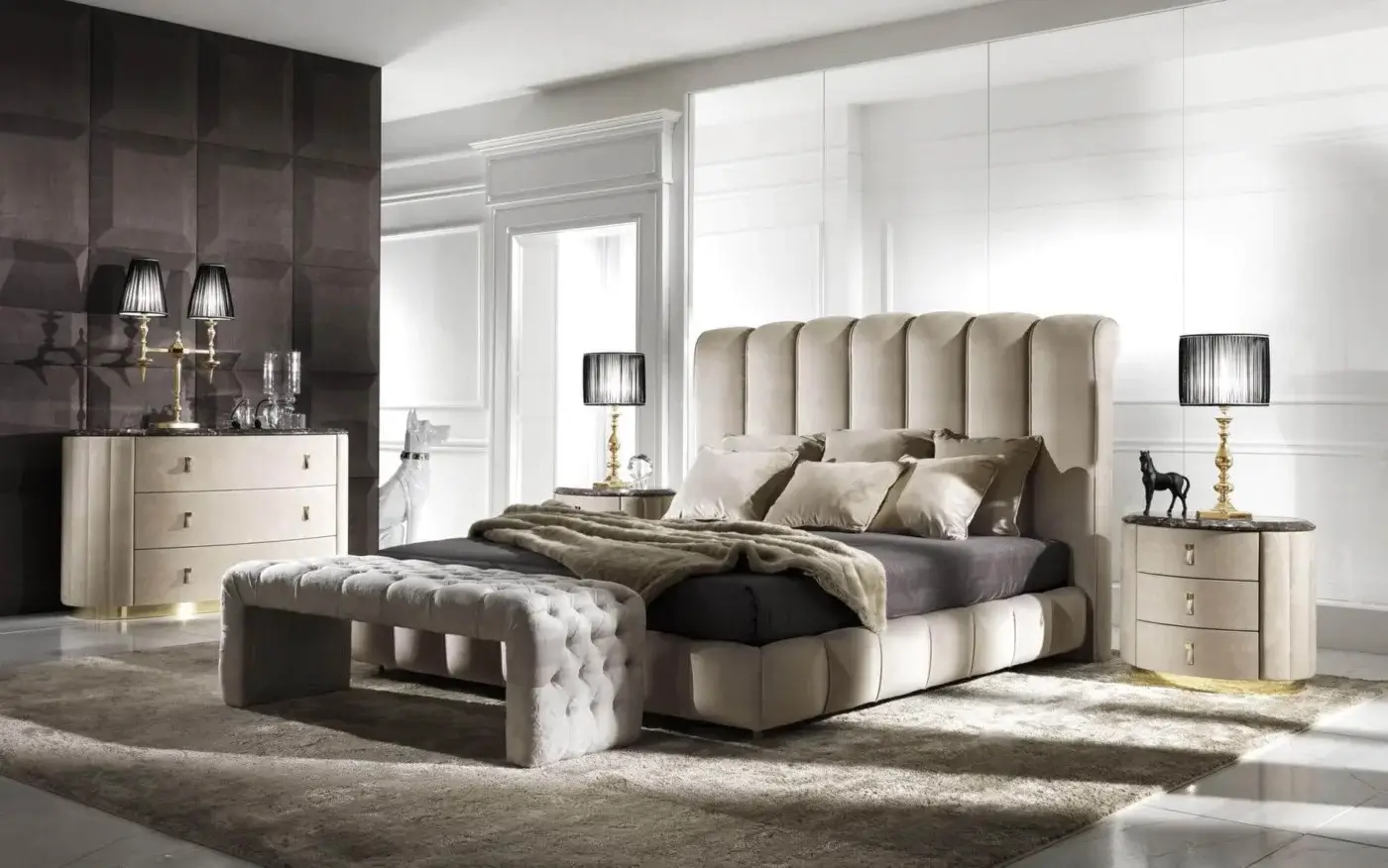 Elegant DV Home Collection Byron bed with vertically channeled light beige upholstery and a dark gray mattress with neutral throws