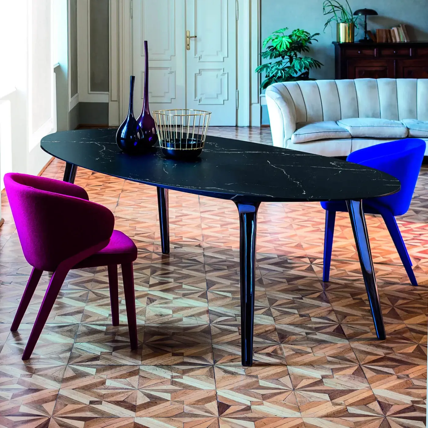 Exclusive Bross Nora armchair upholstered in vibrant magenta-purple fabric with a skillfully crafted wood structure