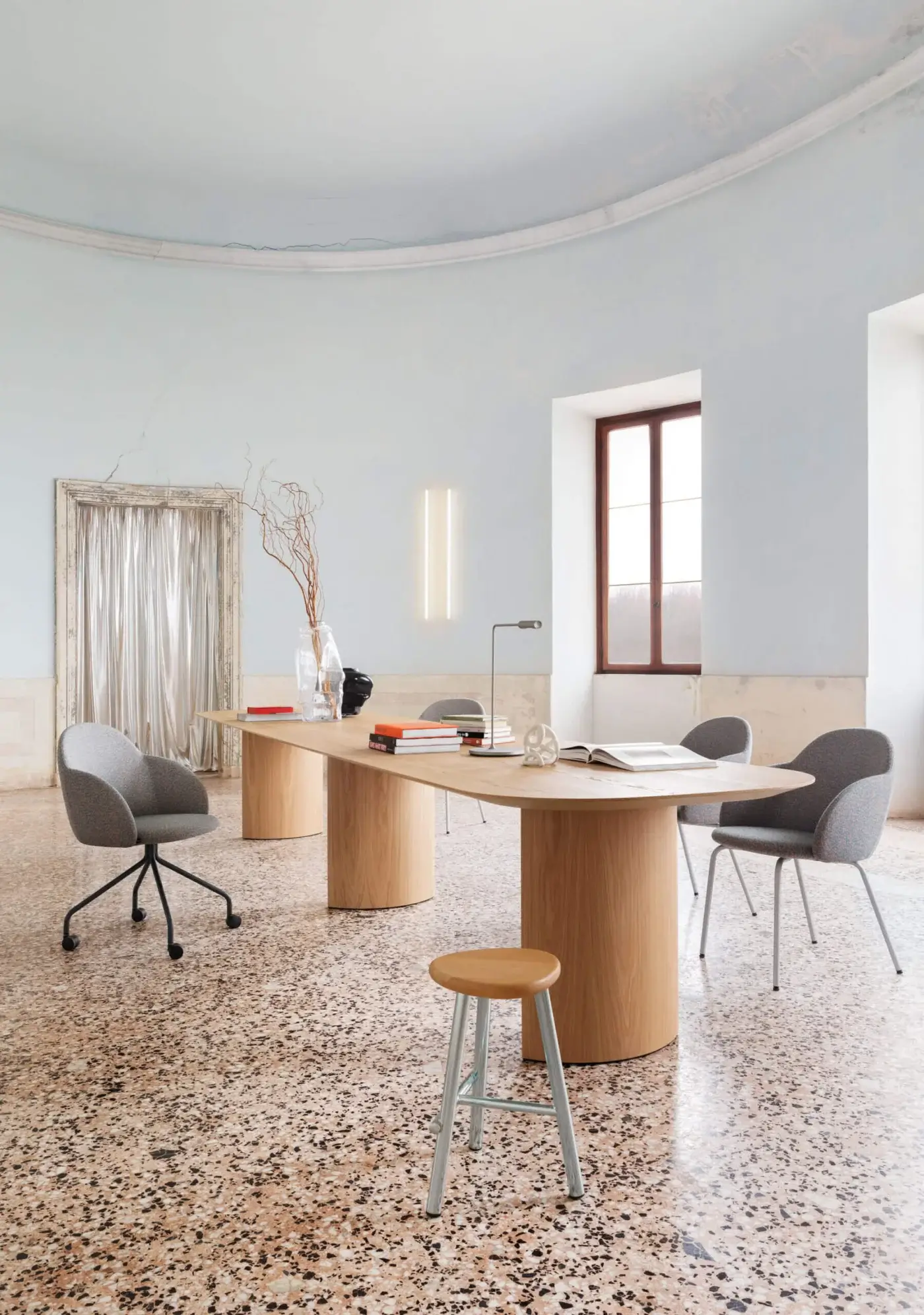 Elegant Miniforms Iola armchair upholstered in sleek grey textile with slender black finished metal legs crafted in Italy