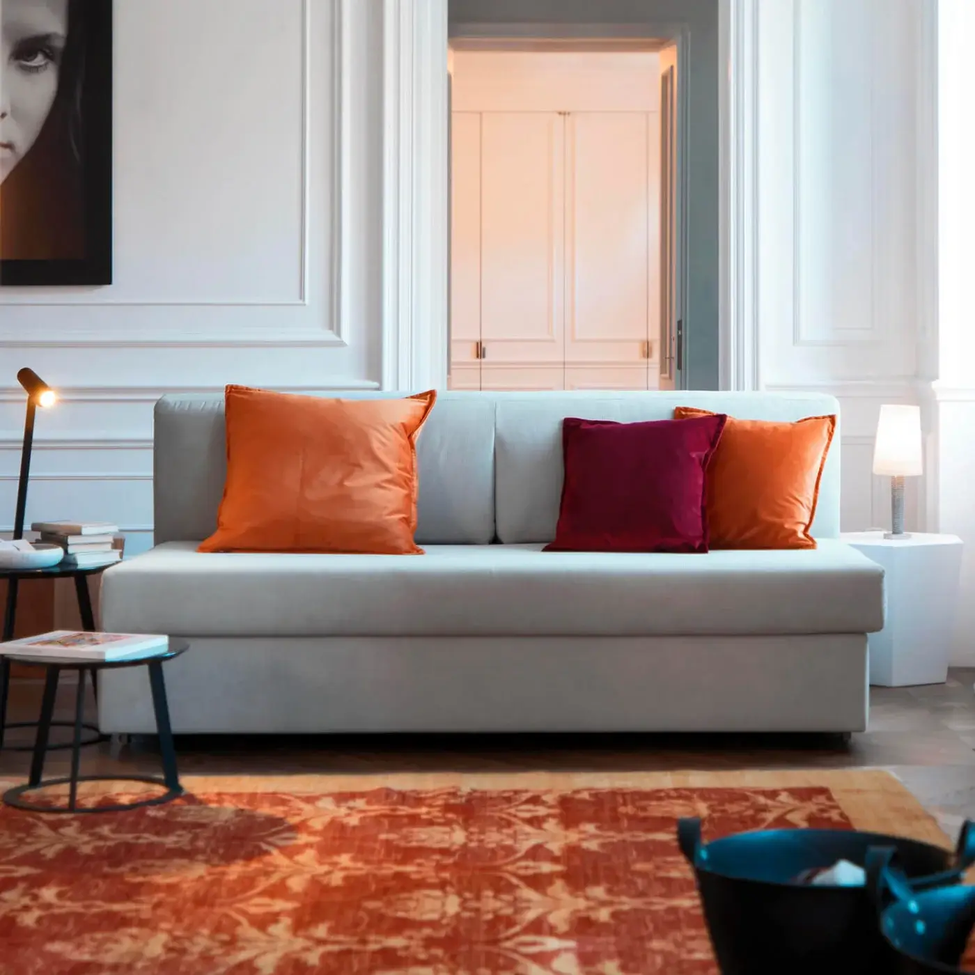 Exceptional Horm Vulcano sofabed with light gray textile upholstery and smooth finish, including orange and burgundy cushions