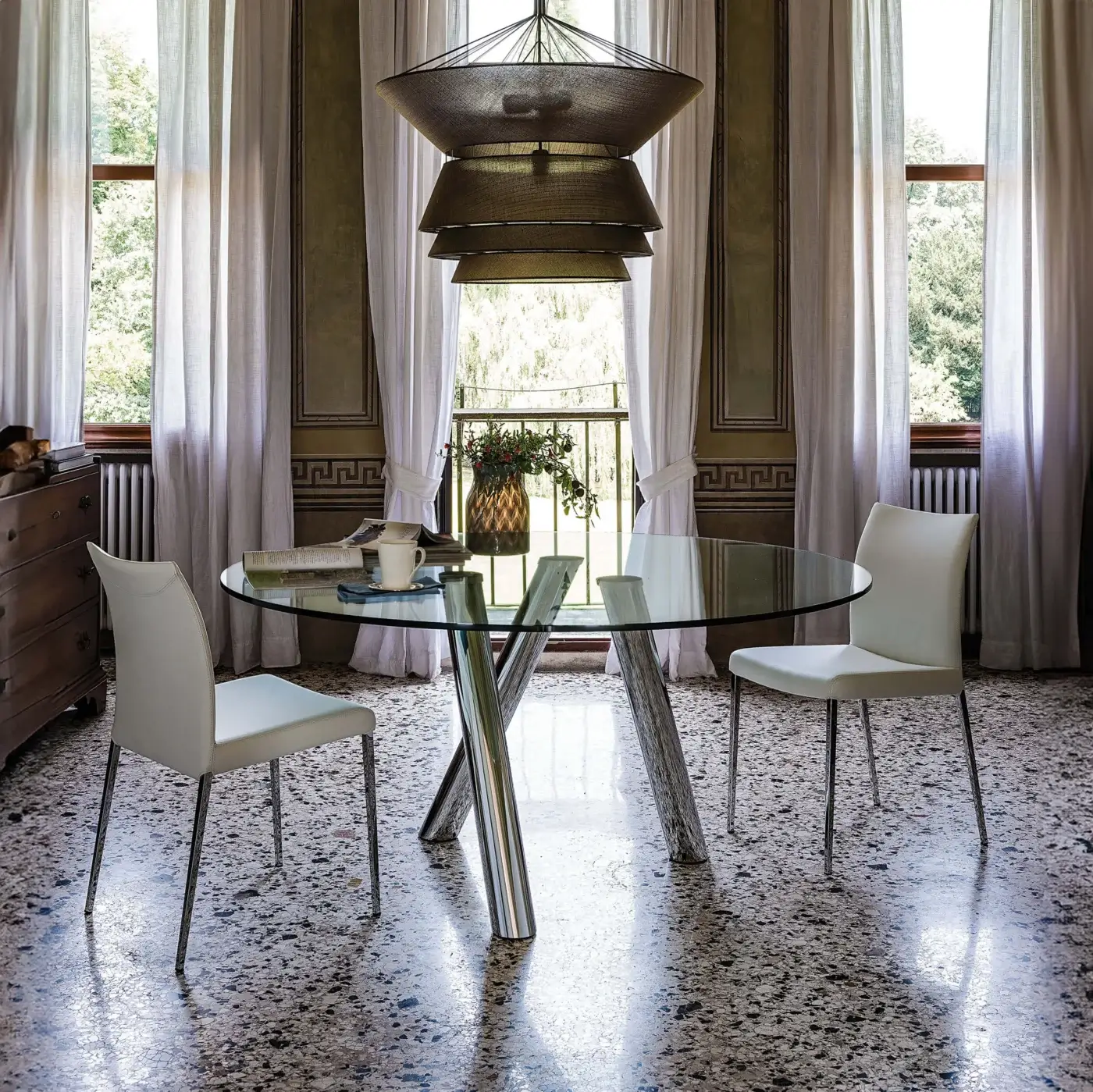 Elegant Cattelan Italia Ray table crafted in glass with a glossy three-legged steel base exhibiting chromed details