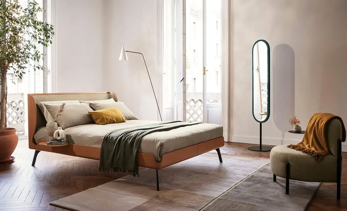 Distinguished Bolzan Letti Gabri bed crafted in Italy with warm tan leather-like upholstery and a lighter beige textile headboard panel