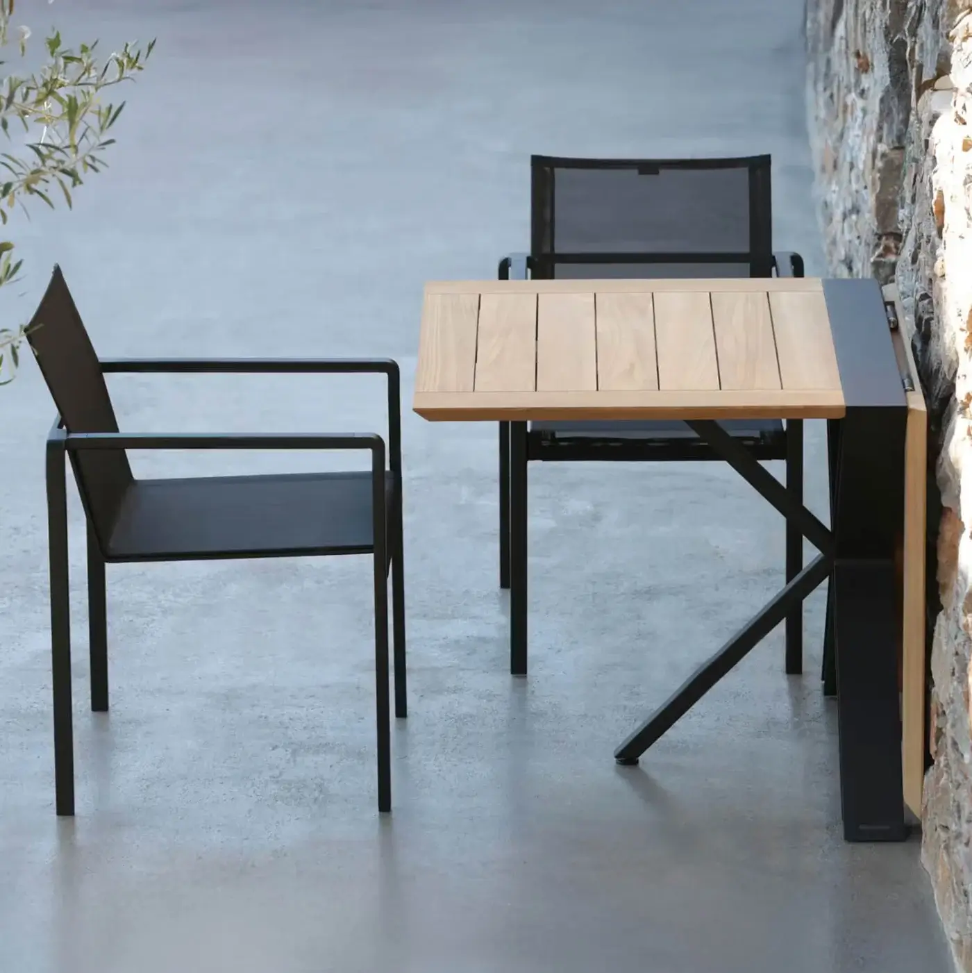 Alluring Royal Botania Alura armchair with geometric silhouette in black textured aluminum and dark seat construction