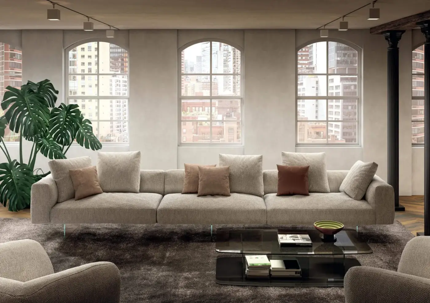 Cassoni modular sofa, light beige fabric, low profile with cushions, gray shag rug, glass coffee table, minimalist room interior.