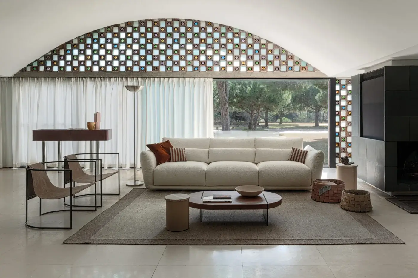 Cierre 1972 "Clift" sofa, beige textured fabric, modular design, jute rug, stone coffee table, colored glass block window.